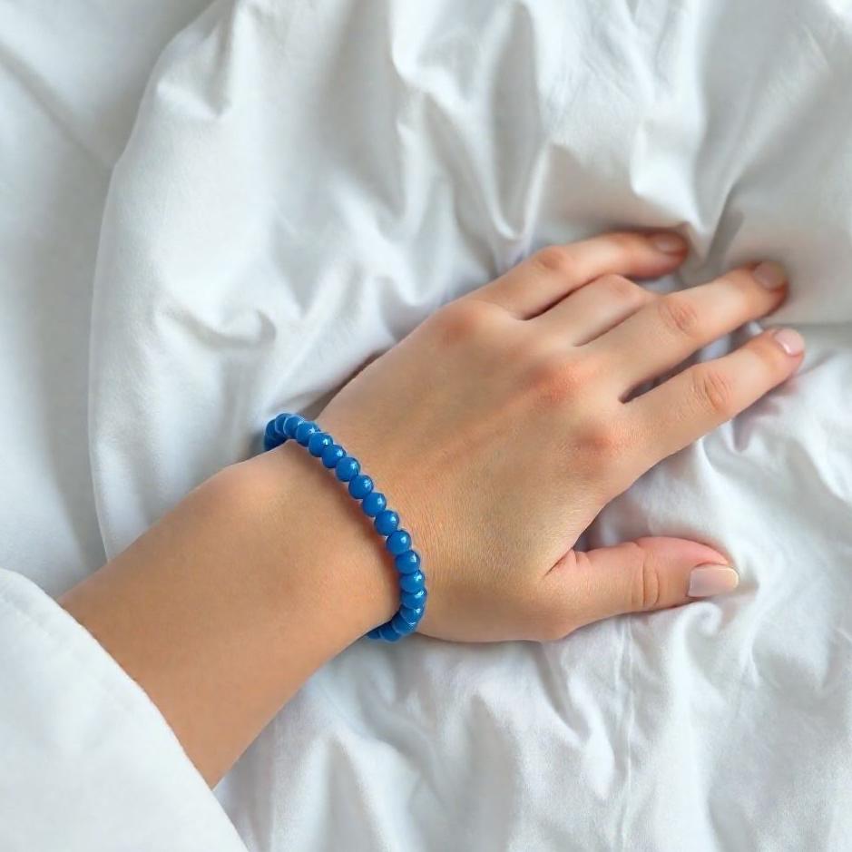Dream : Wearing blue beads on your arm in a dream